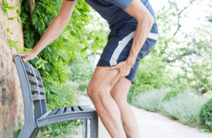 Man Outdoors In Pain With Tight Hamstrings